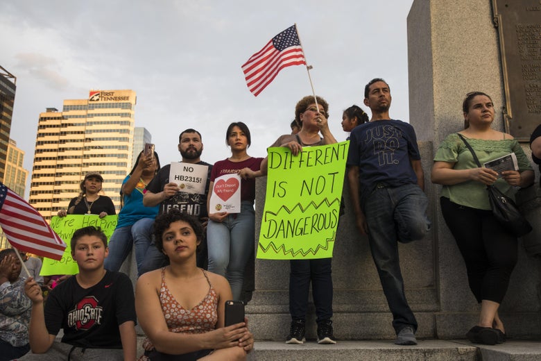 Activists rally and hold signs outside the Tennessee State Capitol